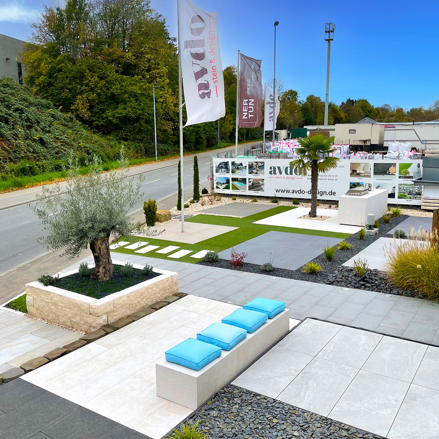 Outdoor-Ausstellung bei avdo design mit verschiedenen Steinarten, Outdoor-Küche, Bepflanzung und Gestaltungsideen