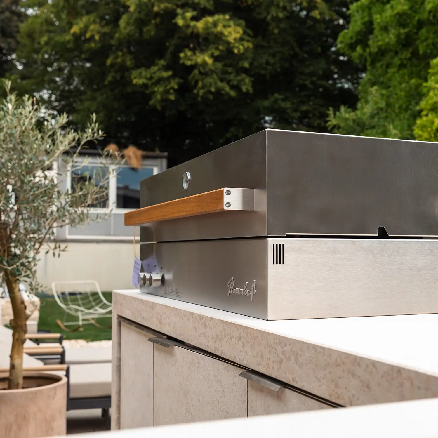 High-End Gas-Grill von Flammkraft integriert in einer Outdoorküche aus Naturstein